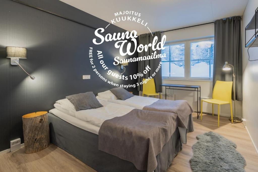 a bedroom with a bed with a sign that reads savannah world synchronizedromy at Kuukkeli Saariselkä Inn in Saariselka