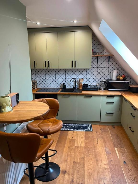 a kitchen with a table and chairs in a room at Green House Giławy in Giławy