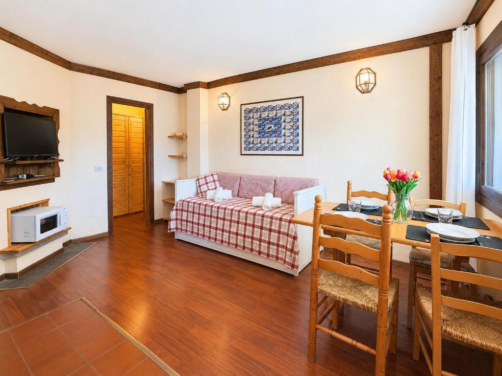 a living room with a table and a couch at Hostdomus - B3-03 in Grange Sises