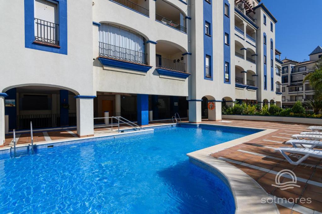 a swimming pool in front of a building at La Marina Solmares in Isla del Moral