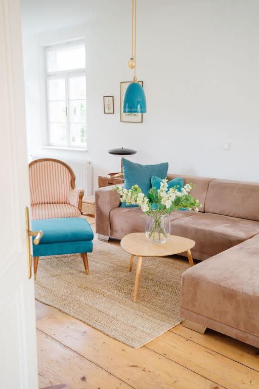 a living room with a couch and a table with flowers at Schmidsdorf 67 in Payerbach