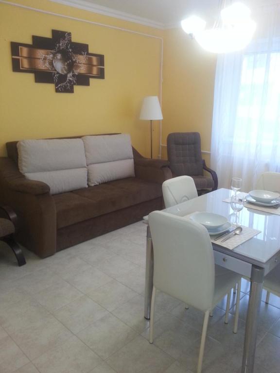 a living room with a couch and a table at Szinva Apartman Miskolc in Miskolc