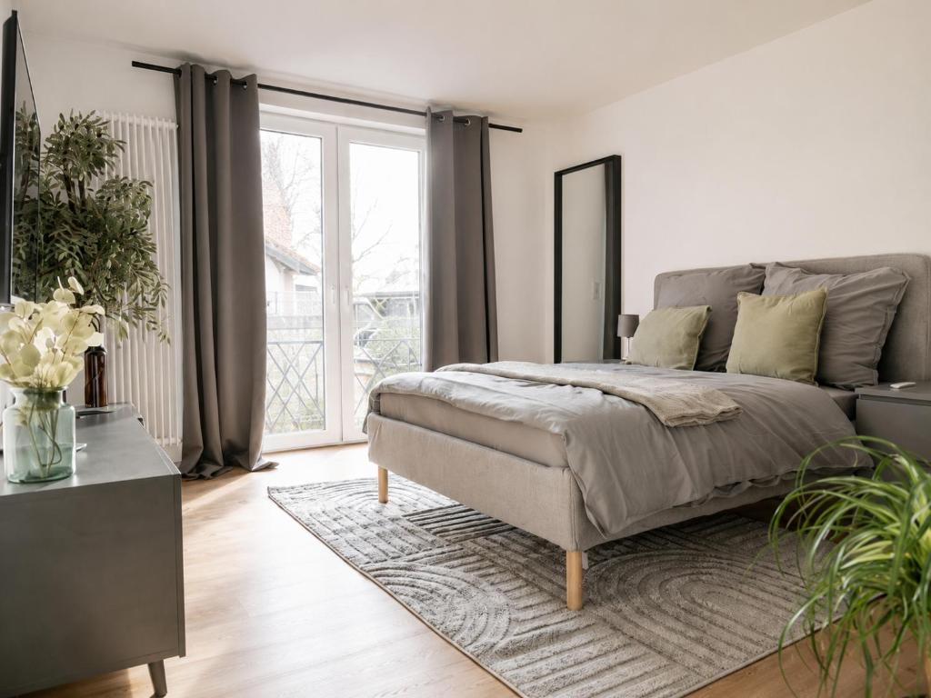 a bedroom with a bed and a large window at MeinZuhause Apartment EG in Bad Pyrmont