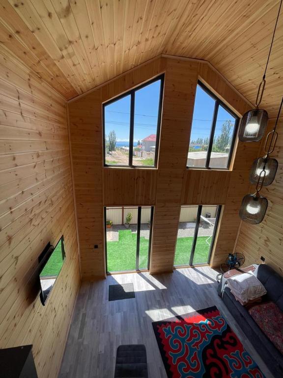an inside view of a wooden cabin with windows at Банрхаус in Cholpon-Ata