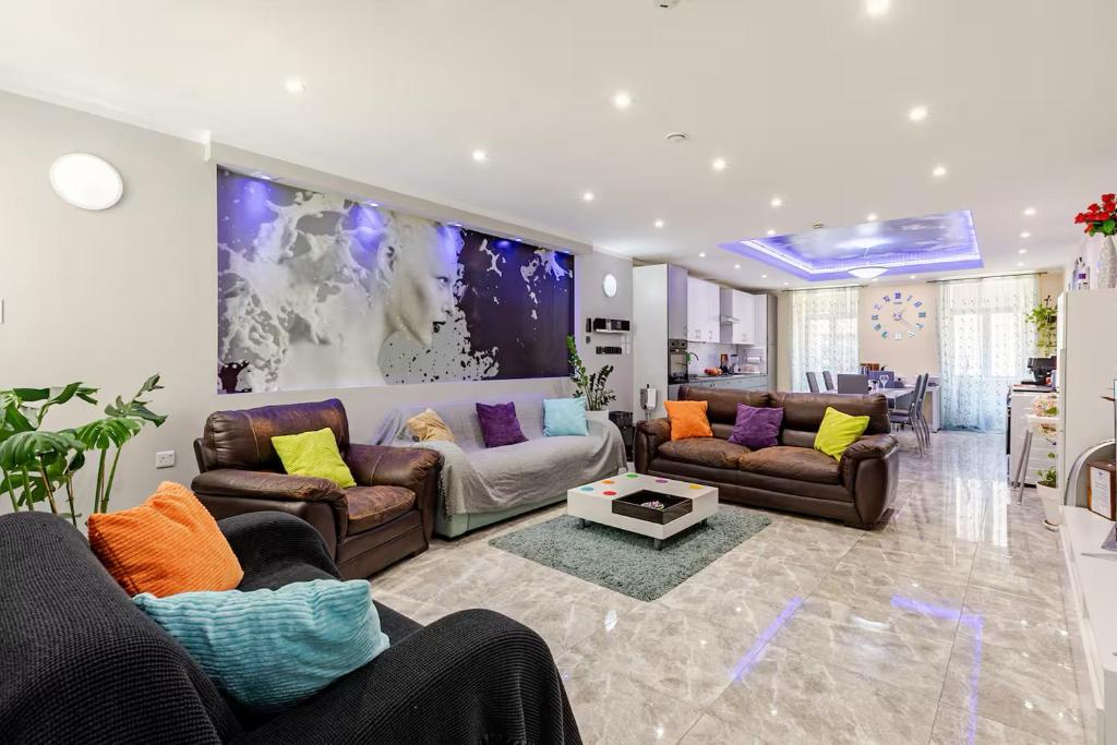 a large living room with couches and a table at Azure Apartment in Senglea