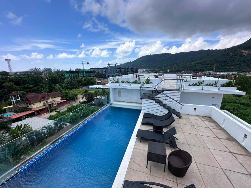 a swimming pool on the roof of a building at Yenna Apt in Kamala Beach