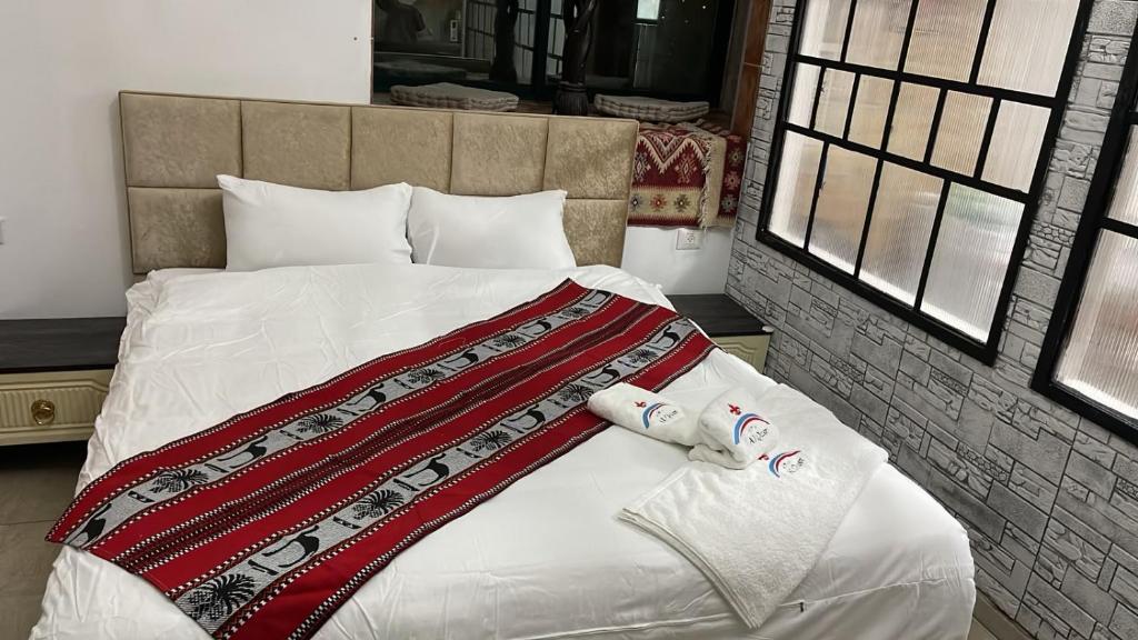 a bedroom with a bed with two towels on it at Al qasr in Mashabbe Sade