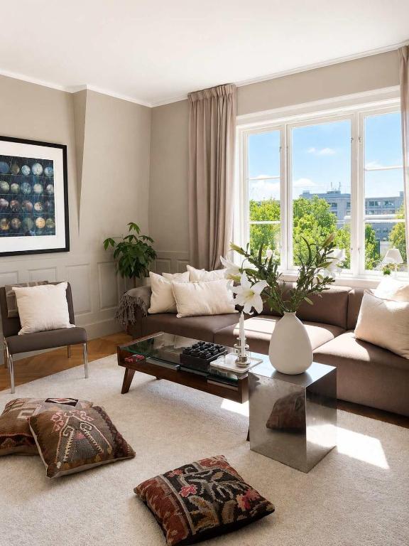 a living room with a couch and a table at SV3G 3BR Villa with Patio in Oslo