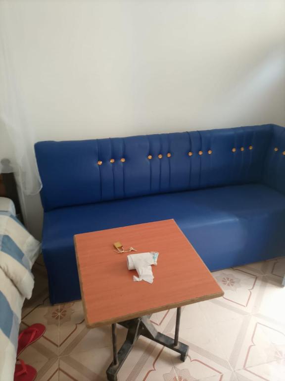 a blue couch with a coffee table in a room at The HIVE in Kitui