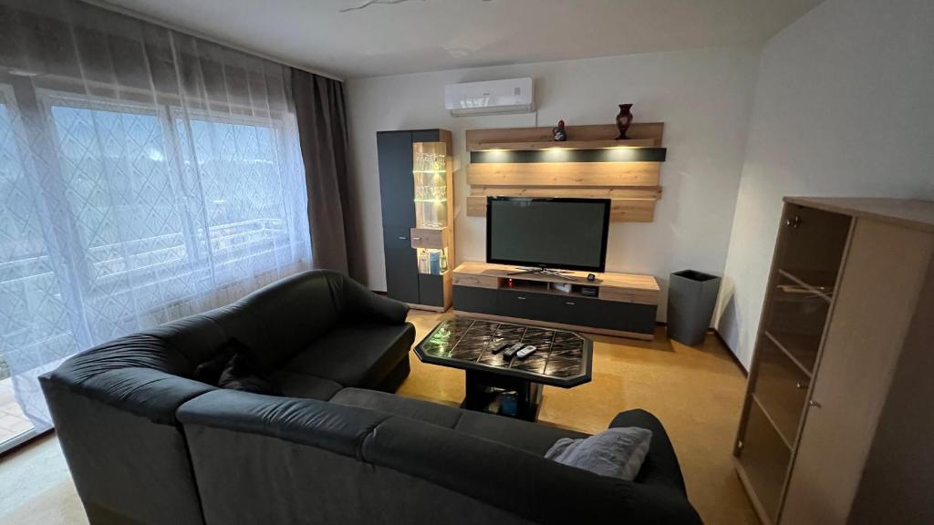 a living room with a couch and a flat screen tv at Apartment Kristian in Selnica ob Dravi