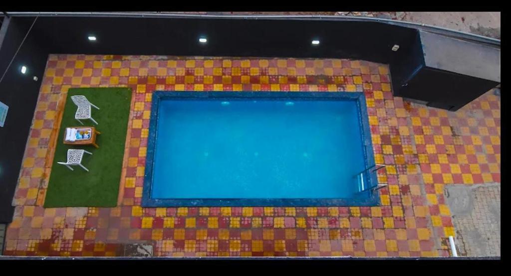 an overhead view of a swimming pool in a building at ll EMPYREAN STAYS ll BLACK PANTHER VILLA ll in Lonavala