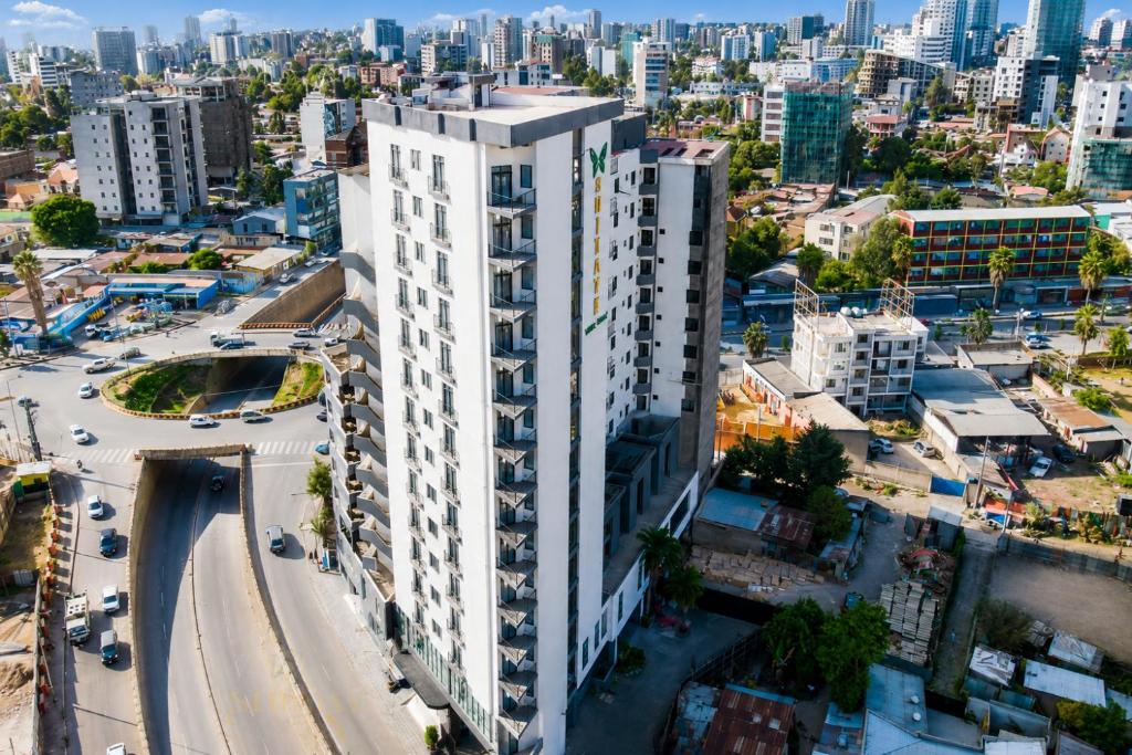 an aerial view of a tall white building in a city at Shitaye Suite Hotel in Addis Ababa