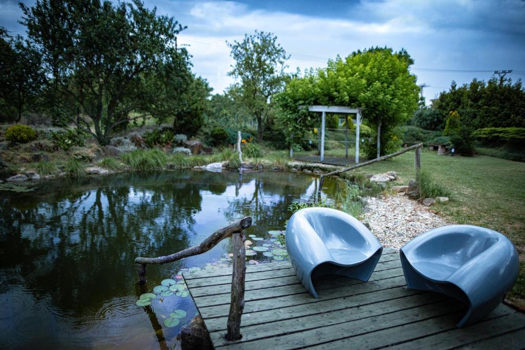 a boat sitting on a dock next to a pond at VILA v ZAHRADÁCH in Uherské Hradiště
