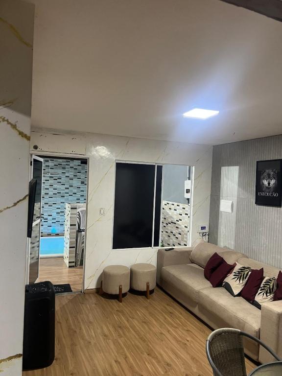 a living room with a couch and a flat screen tv at Casa Maceió The perfect place in Maceió