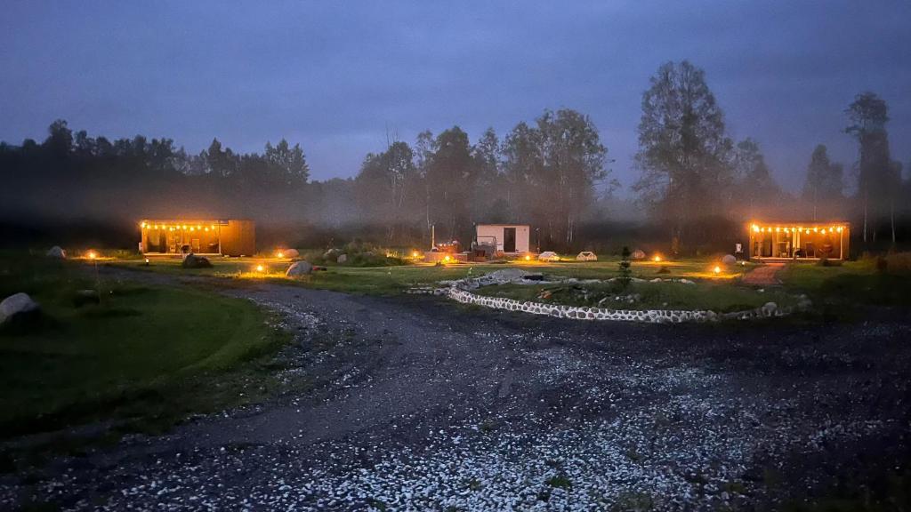 a night scene of a river with buildings and lights at Mesipesa Holiday Houses in Narva-Jõesuu