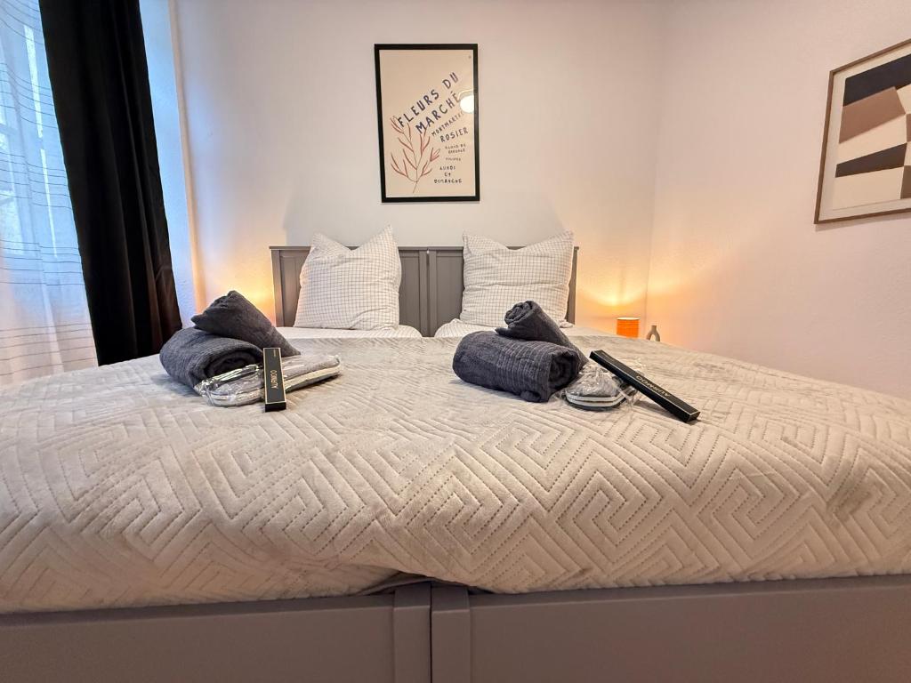 a large bed with towels on top of it at Stage One City in Andernach