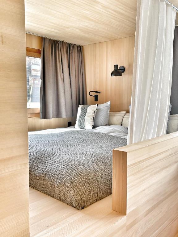 a bedroom with a bed and a window at Tinyhouse Style in Obergesteln