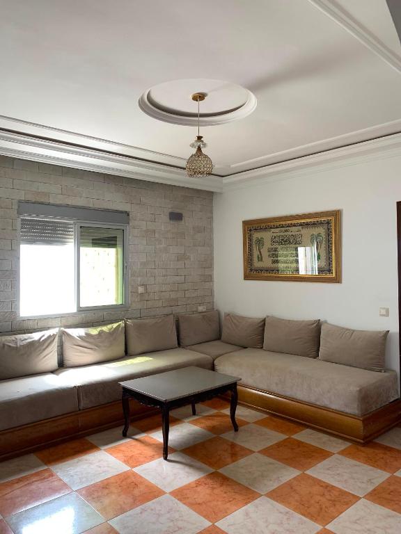 a living room with a couch and a coffee table at maison avec jardin in Cabo Negro