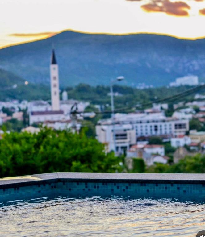 a swimming pool with a view of a city at Apart Mostar in Mostar