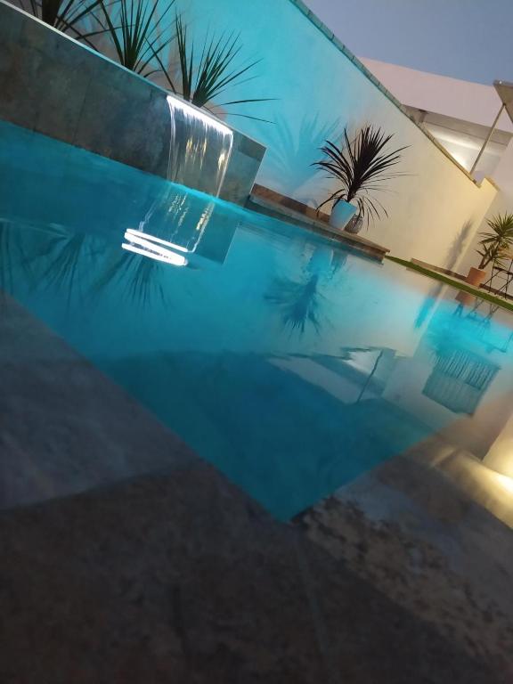 a swimming pool with a reflection in the water at Casa Martina in Cádiz