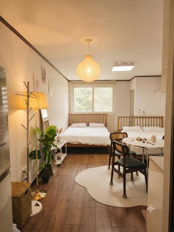 a bedroom with a bed and a table and a desk at Seoul Station condo in Seoul