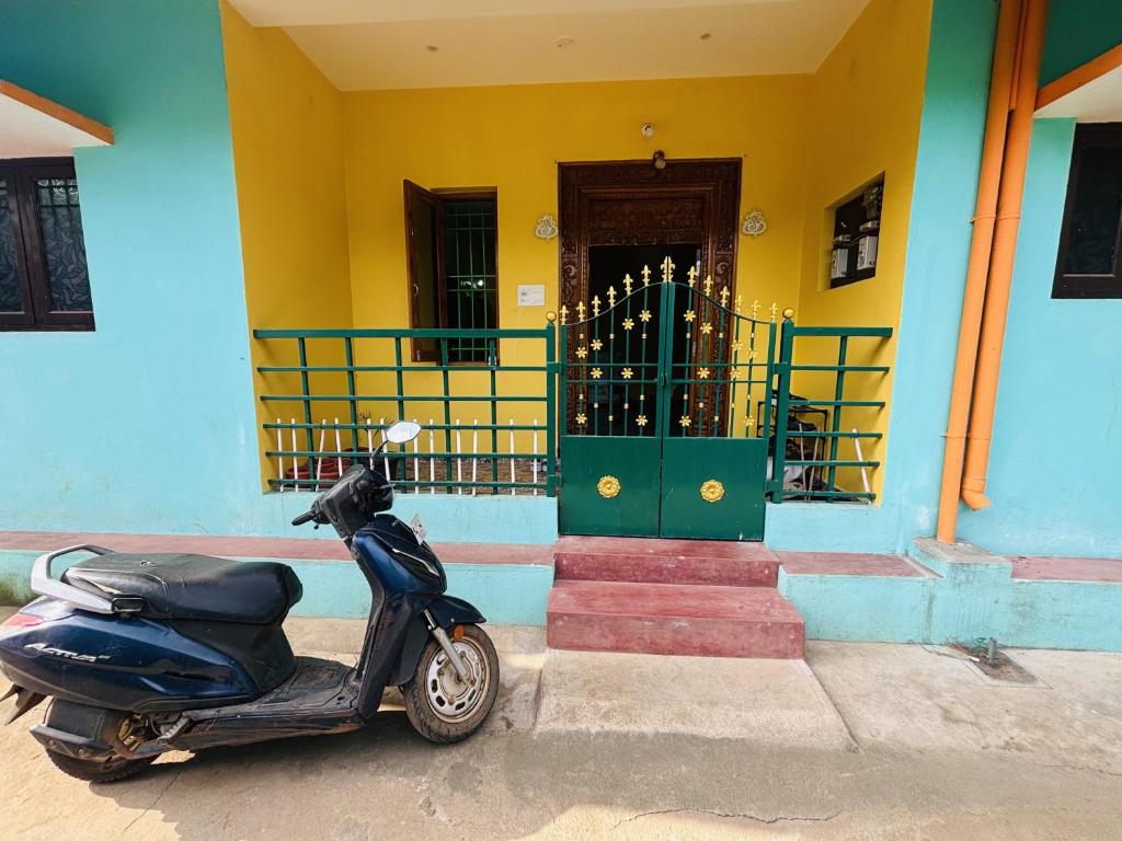 a scooter parked in front of a house at Sunrise Strength Club in Villupuram