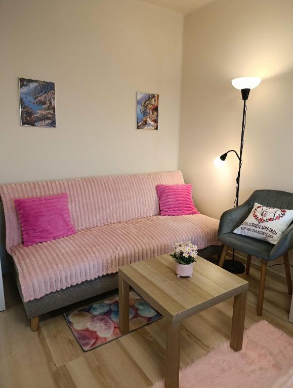 a living room with a couch and a table at Móra Corner Apartman Mezőkövesd in Mezőkövesd