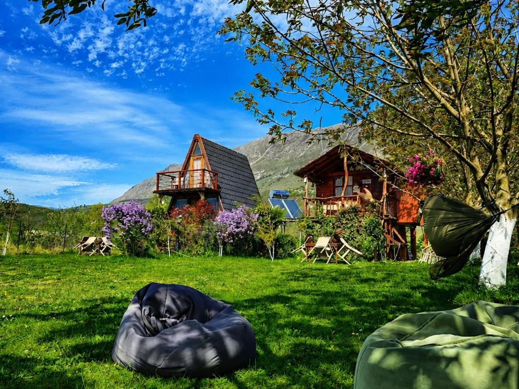 a house with a sleeping bag on the grass at Life on the farm in Nepravishtë