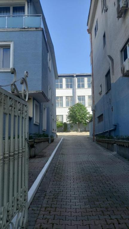 a cobblestone street with a fence next to a building at Vila Ali Demi in Tirana