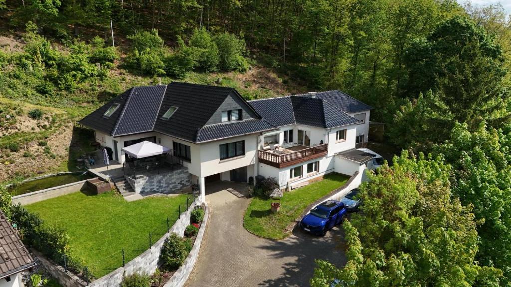 an aerial view of a house with a blue car at FeWo Roll in Plettenberg