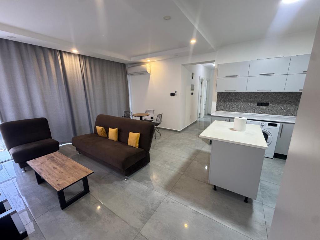 a living room with a couch and a kitchen at Joy Residence- 3 bedroom apartment with balcony in Nicosia