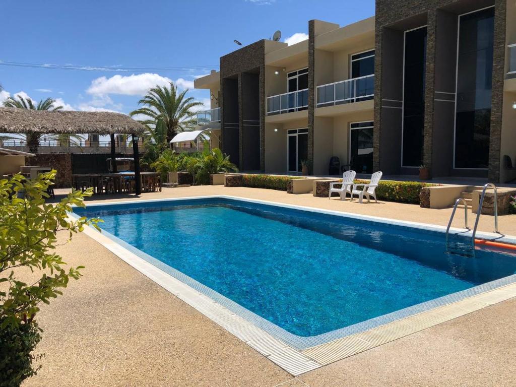 a swimming pool in front of a building at Yaque Land in El Yaque