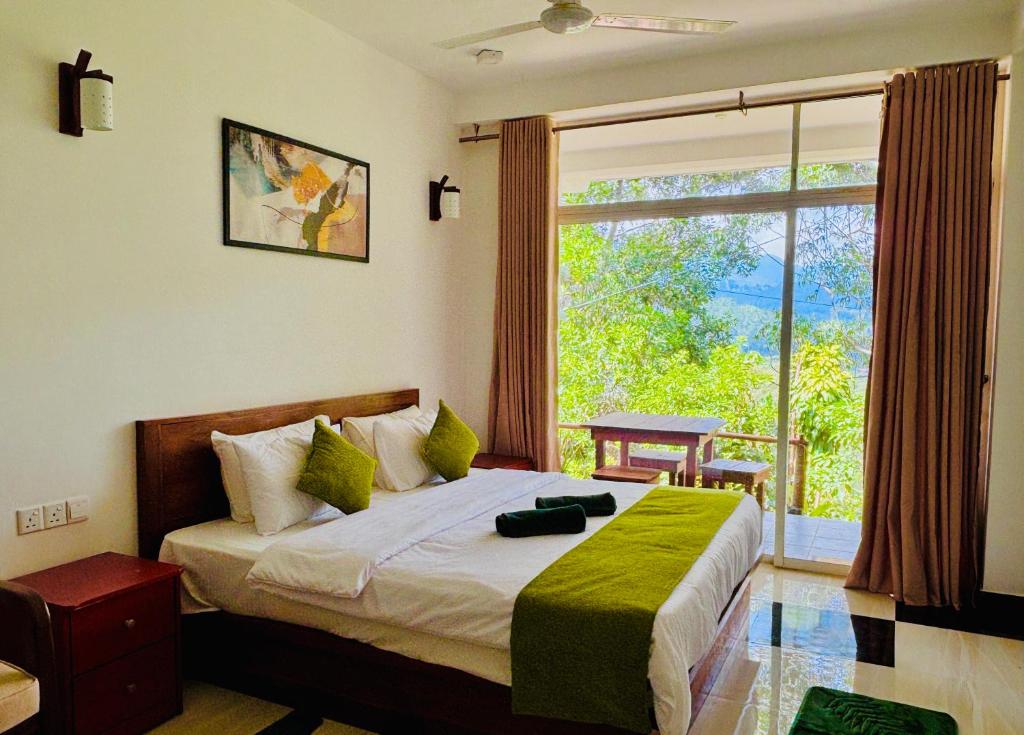 a bedroom with a bed and a large window at Ella Pine Crest in Ella
