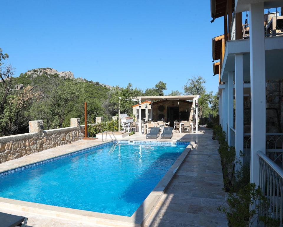 a swimming pool next to a house at Petra Evleri in Örencik