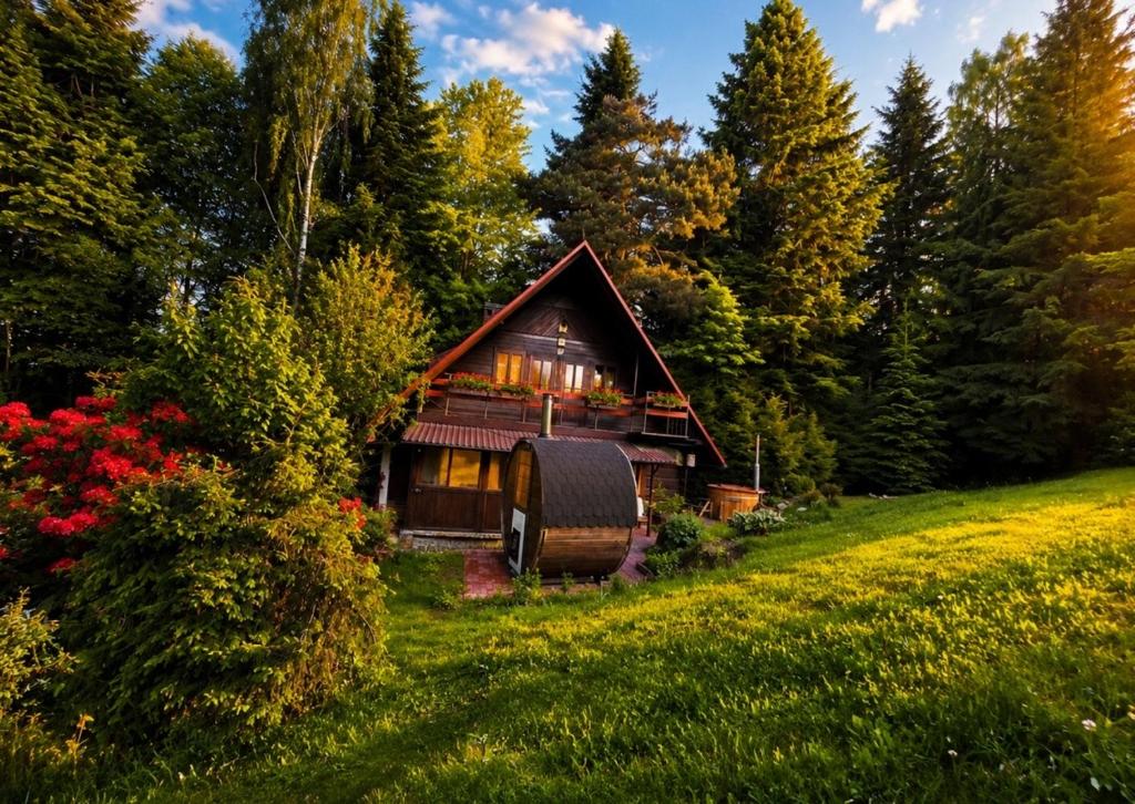 a cabin in the woods with a barrel in front of it at Chata pod lasem z balią i sauną in Myślenice