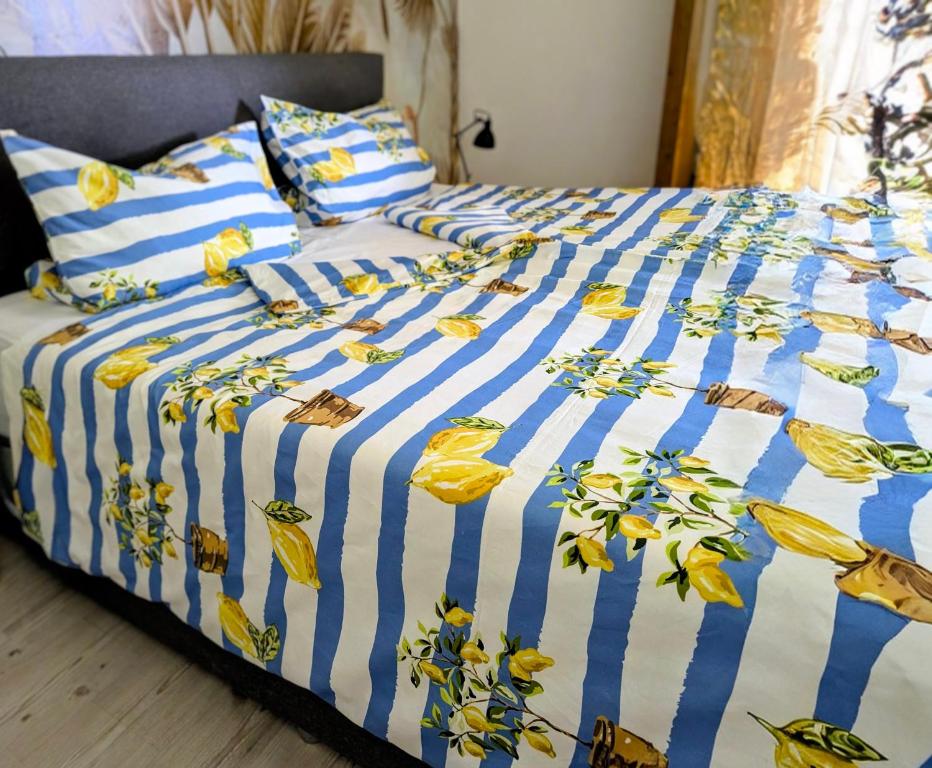 a bed with a blue and white blanket and pillows at Apfelblüte in Stockach