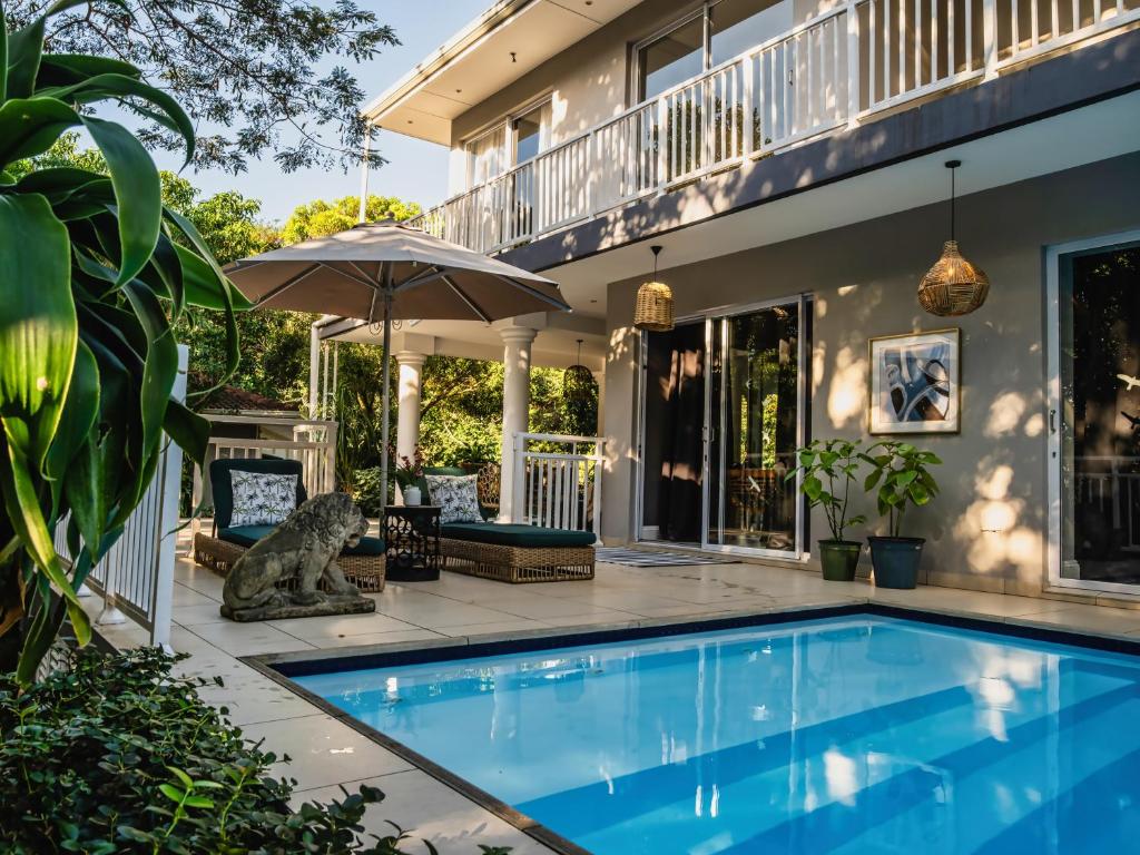 a swimming pool in front of a house at Palmtree Luxury Villa Eden Rock Estate, Pennington in Pennington