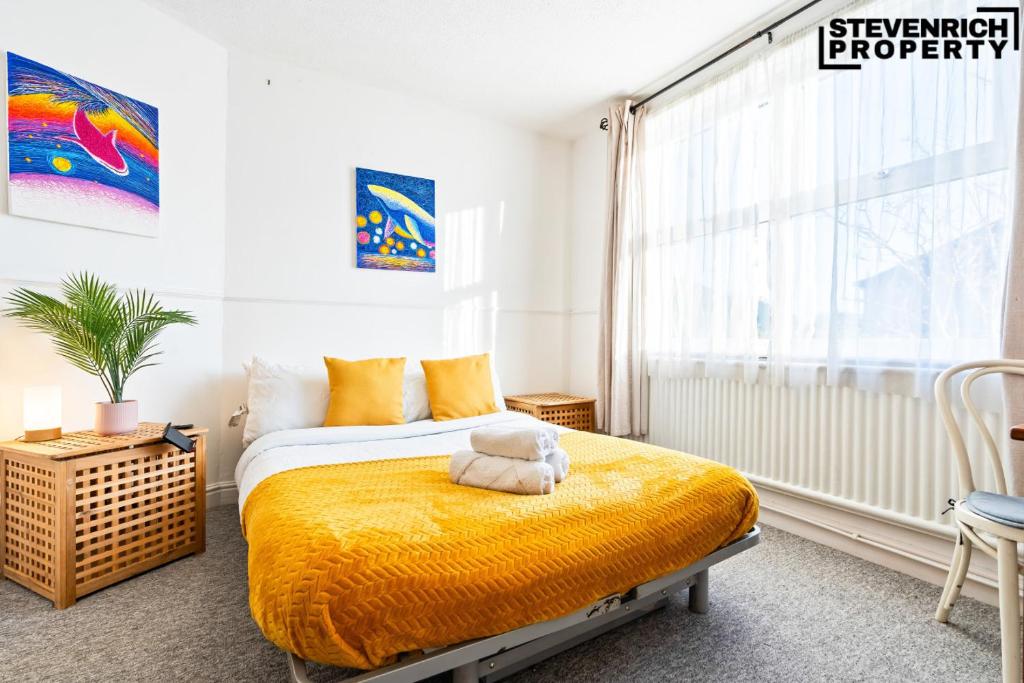 a bedroom with a bed with a teddy bear on it at Group Stays, 4 Bedroom, Spacious Home in BS4, Van & Car Parking, Sleeps 7 in Bristol
