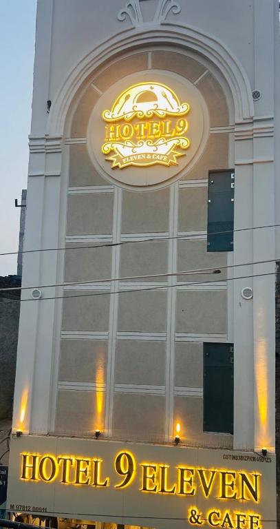 a hotel sign on the side of a building at Hotel 9Eleven & Cafe in Barnāla