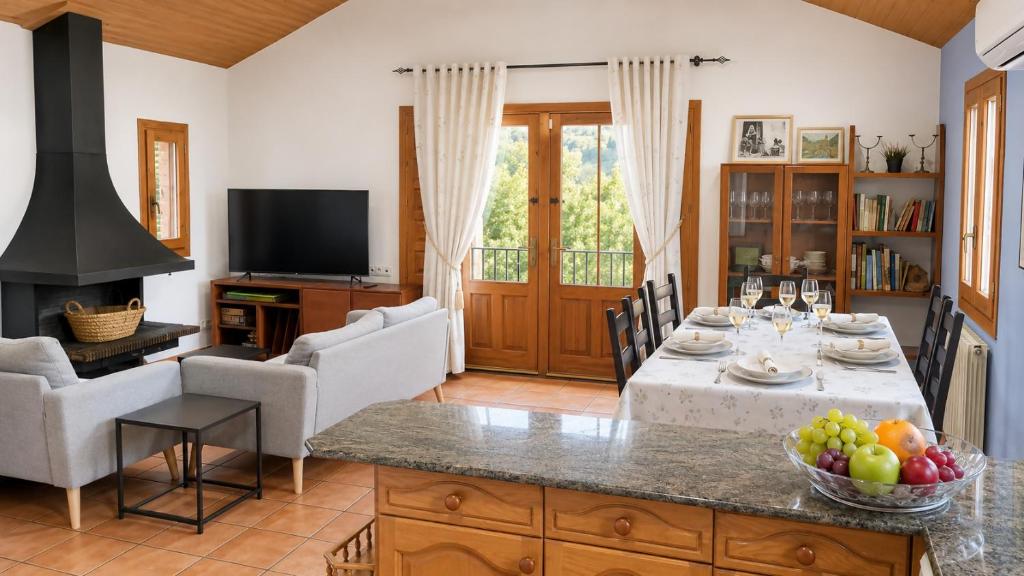 a living room with a table with a bowl of fruit at El Cajigar Ordesa Aínsa in Laspuña