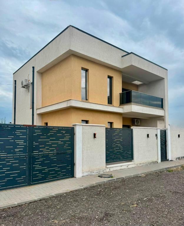 a building with a fence in front of it at Vila Lux Braila in Brăila