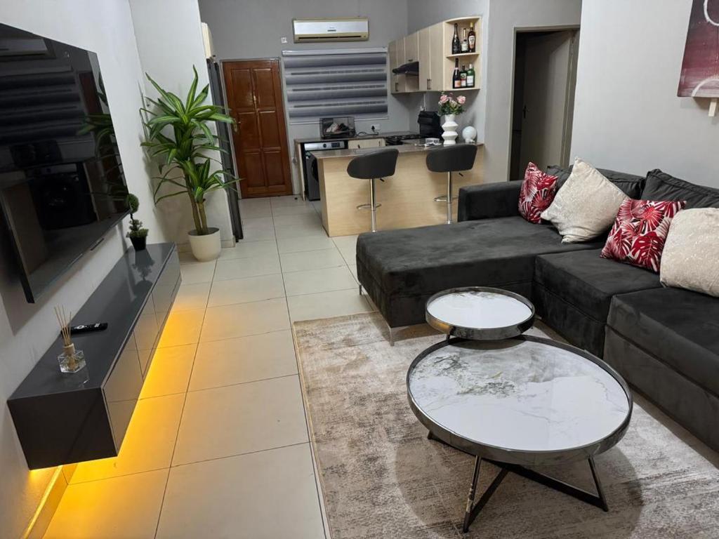 a living room with a couch and a table at Home Very Close To CBD in Gaborone