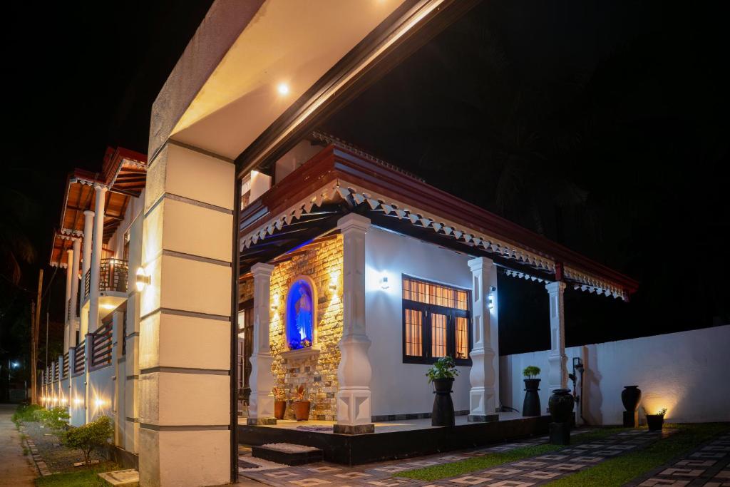 a building with a blue light on the side of it at Regal Retreat in Mahawatta