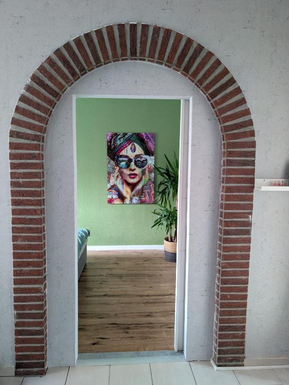 an archway in a room with a painting of a clown at Chez D&D Plus in Eschweiler