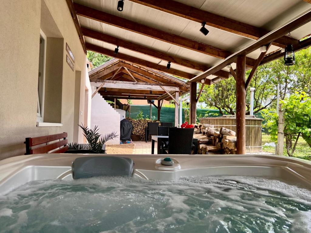 a jacuzzi tub in the backyard of a house at Zselic Kuckó by Mártika in Szigetvár