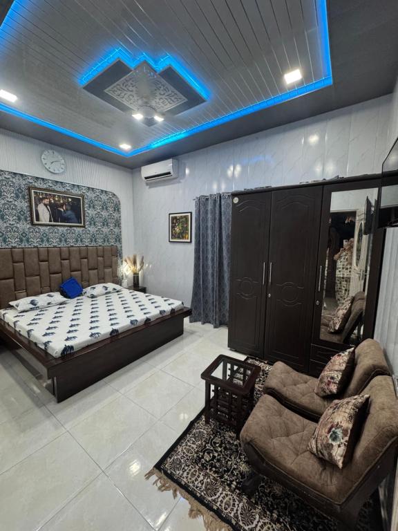a bedroom with a bed and a couch in it at Homestay, hotel at Pathankot in Pathānkot