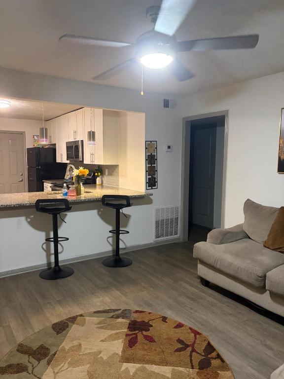 a living room with a kitchen and a couch at Stylish Decatur Retreat in Decatur