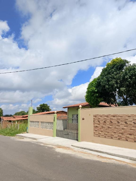 a house on the side of a street with a fence at Bom Viver Pousada-Viçosa do Ceará -CE in Viçosa do Ceará