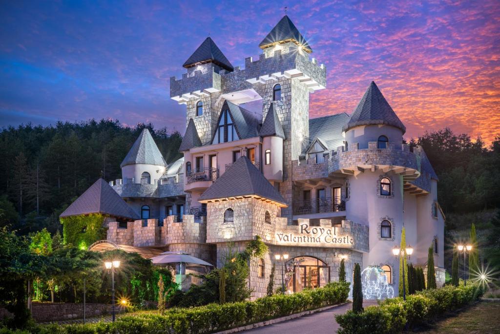 a castle in the middle of the forest at night at Royal Valentina Castle in Ognyanovo