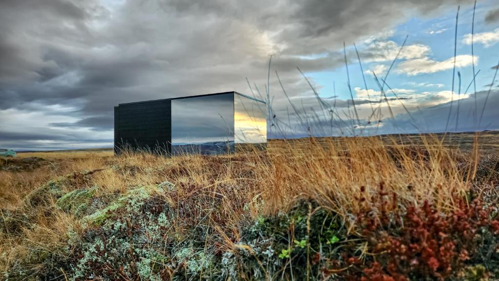 a black box in a field of tall grass at Mystic Light Lodge in Búðardalur